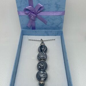 Exquisite Black & Silver Swirl Necklace
Expertly Handcrafted, Exclusively Yours